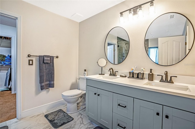 16755 Sunrise Vista Dr, Clermont, FL 34714 - bathroom featuring baseboards, marble finish floor, a sink, and toilet