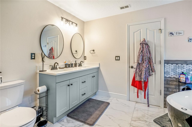 16755 Sunrise Vista Dr, Clermont, FL 34714 - full bathroom with marble finish floor, visible vents, toilet, and a sink