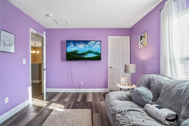 16755 Sunrise Vista Dr, Clermont, FL 34714 - living area featuring baseboards, wood finished floors, and a textured ceiling