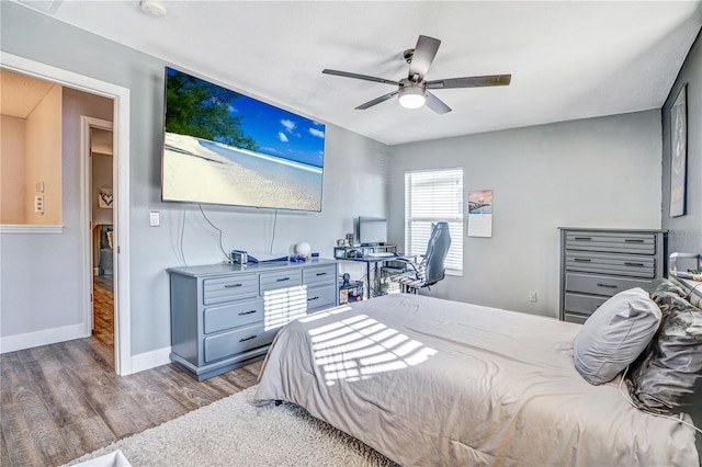 16755 Sunrise Vista Dr, Clermont, FL 34714 - bedroom with baseboards, wood finished floors, and ceiling fan