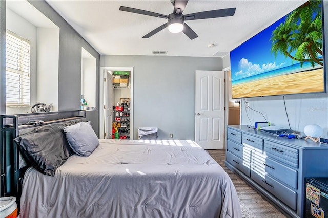 16755 Sunrise Vista Dr, Clermont, FL 34714 - bedroom with dark wood-style floors, visible vents, and ceiling fan