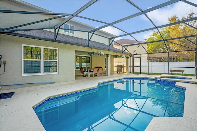 16755 Sunrise Vista Dr, Clermont, FL 34714 - view of pool featuring a pool with connected hot tub, area for grilling, a lanai, a patio, and outdoor dining area