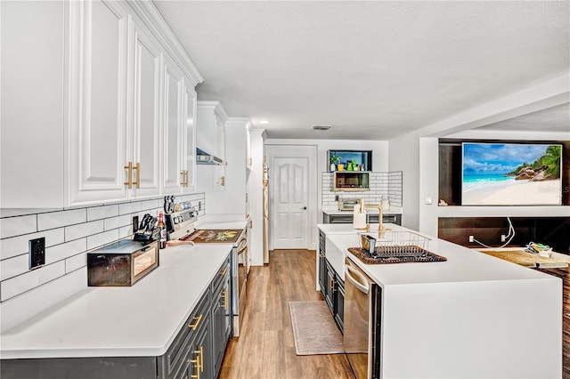 16755 Sunrise Vista Dr, Clermont, FL 34714 - kitchen with white cabinets, stainless steel electric stove, and light countertops