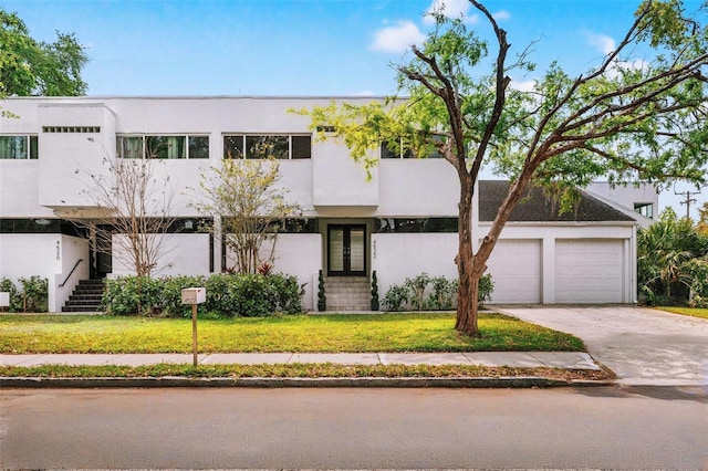 4522 W N B St, Tampa, FL 33609 - view of front of property with a front yard, concrete driveway, and stucco siding