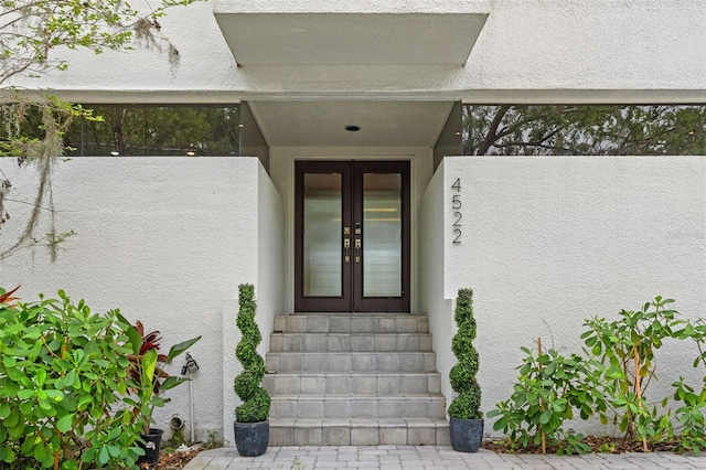 4522 W N B St, Tampa, FL 33609 - view of exterior entry featuring stucco siding and french doors