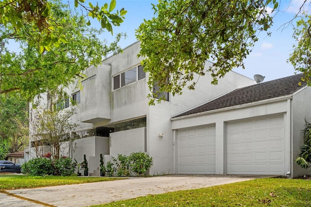 4522 W N B St, Tampa, FL 33609 - view of front of house with stucco siding, an attached garage, and concrete driveway