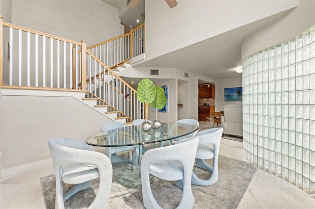4522 W N B St, Tampa, FL 33609 - dining space with baseboards, stairs, a high ceiling, and visible vents