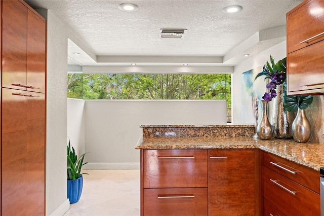 4522 W N B St, Tampa, FL 33609 - interior space featuring plenty of natural light, a textured ceiling, stone counters, and a peninsula