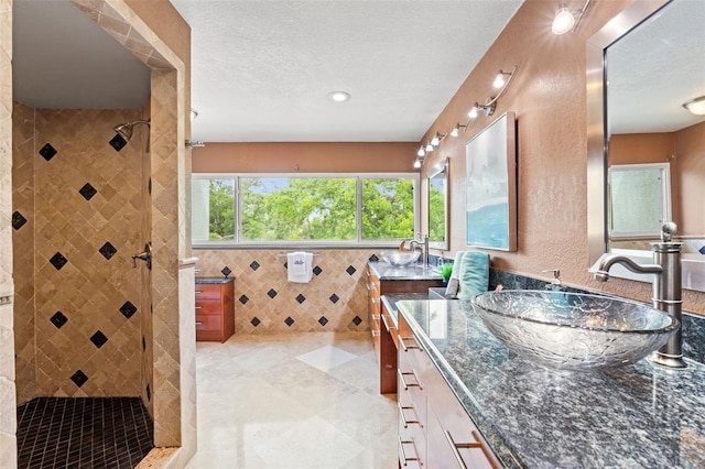 4522 W N B St, Tampa, FL 33609 - full bathroom with tile walls, a tile shower, vanity, and a textured ceiling