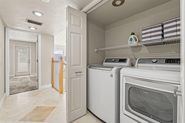 4522 W N B St, Tampa, FL 33609 - laundry room featuring baseboards, a textured ceiling, visible vents, washing machine and dryer, and laundry area