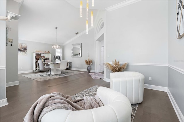 living area featuring crown molding, wood finished floors, baseboards, high vaulted ceiling, and a notable chandelier