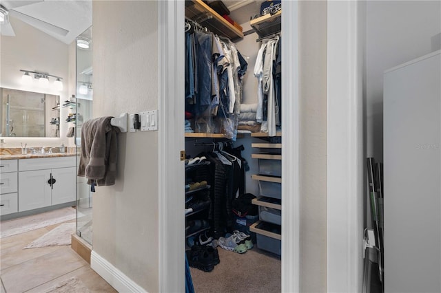 walk in closet featuring a sink