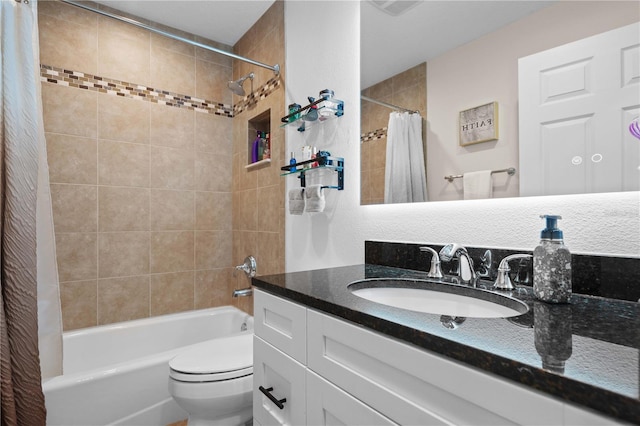 bathroom featuring toilet, shower / bath combo, and vanity