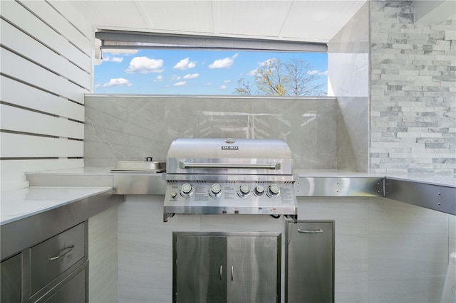 view of patio with area for grilling and a grill