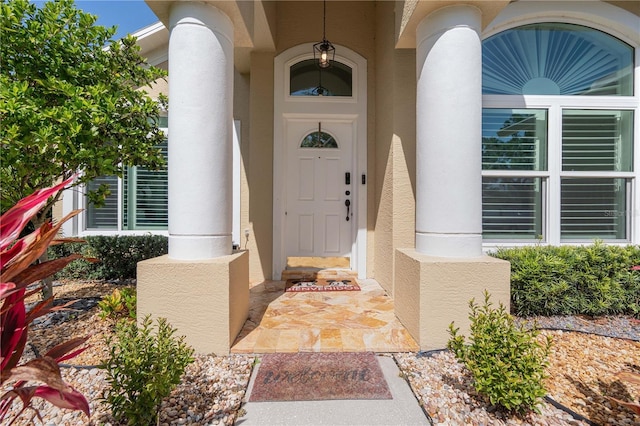 entrance to property featuring stucco siding