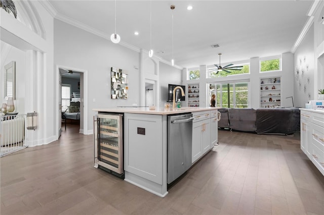 kitchen featuring stainless steel dishwasher, a ceiling fan, wine cooler, and open floor plan