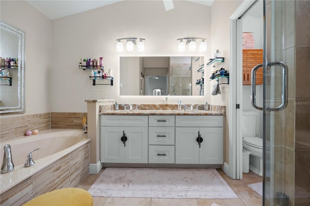 bathroom featuring double vanity, a garden tub, a stall shower, a sink, and tile patterned floors