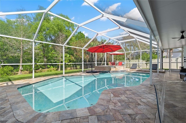 view of pool featuring a fenced in pool, glass enclosure, ceiling fan, and a patio area