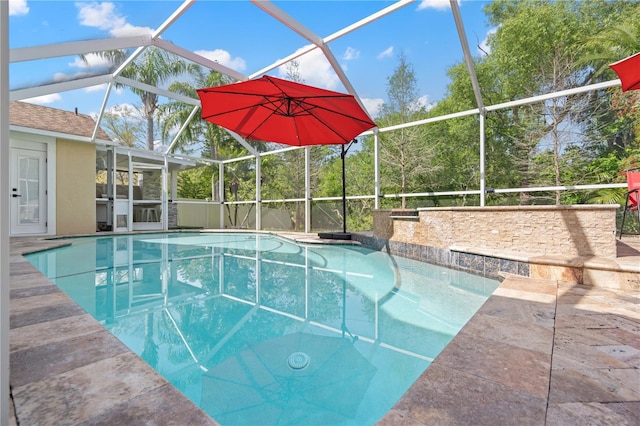 outdoor pool featuring a lanai and a patio area
