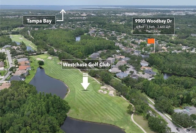 birds eye view of property featuring a water view and view of golf course
