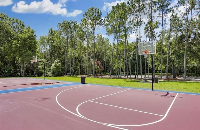 view of basketball court with basketball court and a yard