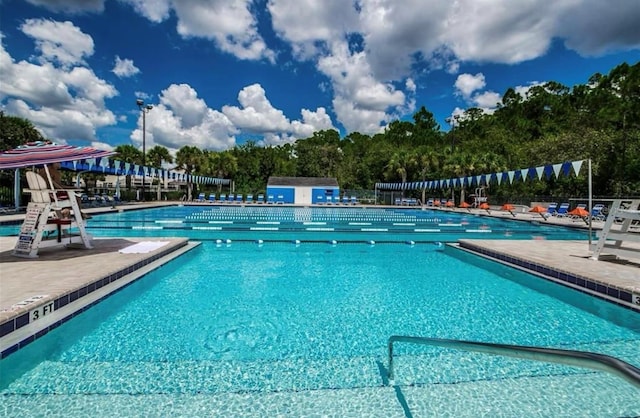 community pool featuring a patio and fence