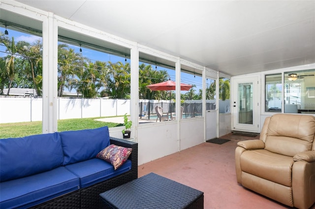 sunroom with a healthy amount of sunlight and outdoor lounge area