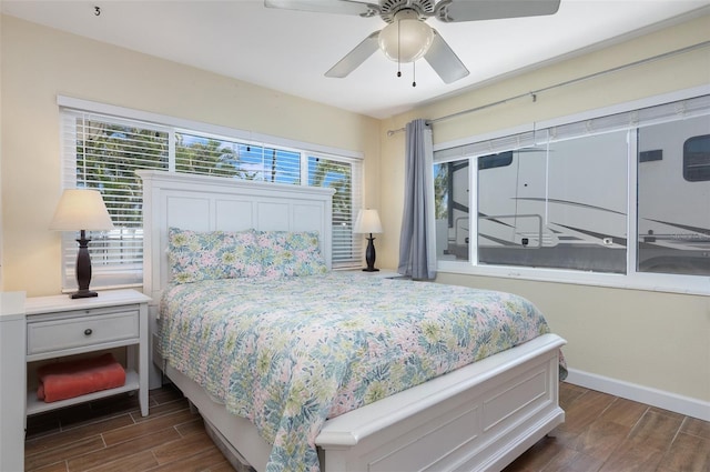bedroom with baseboards, ceiling fan, and wood tiled floor