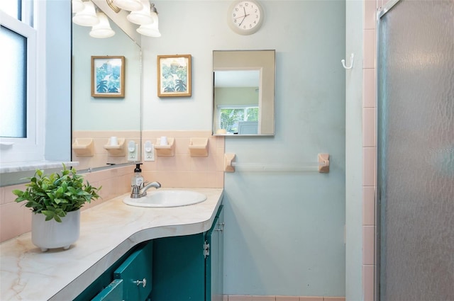 bathroom featuring vanity and tasteful backsplash
