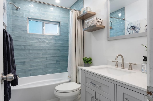 bathroom featuring toilet, vanity, and shower / tub combo