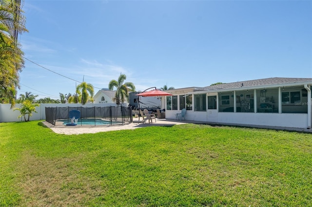 view of yard featuring a fenced backyard, a fenced in pool, a sunroom, and a patio