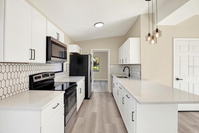 kitchen with light wood-style floors, light stone countertops, a sink, stainless steel appliances, and backsplash