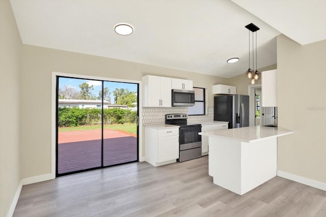 kitchen featuring a peninsula, white cabinetry, light countertops, stainless steel appliances, and decorative backsplash