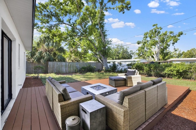 wooden terrace featuring fence and an outdoor living space with a fire pit