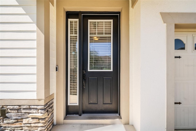 property entrance featuring stone siding