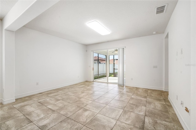unfurnished room featuring visible vents, baseboards, and light tile patterned flooring
