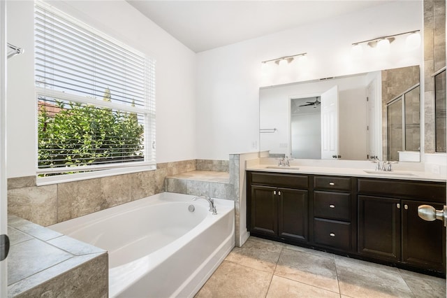 bathroom featuring double vanity, a bath, a sink, and a stall shower