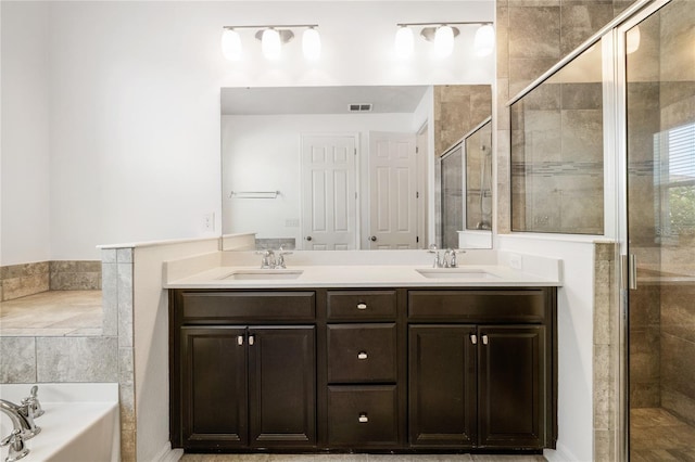 full bath featuring a bath, a stall shower, a sink, and visible vents