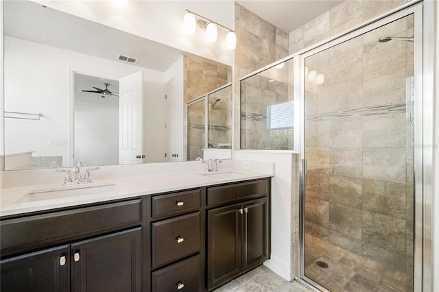 full bathroom with a shower stall, double vanity, visible vents, and a sink