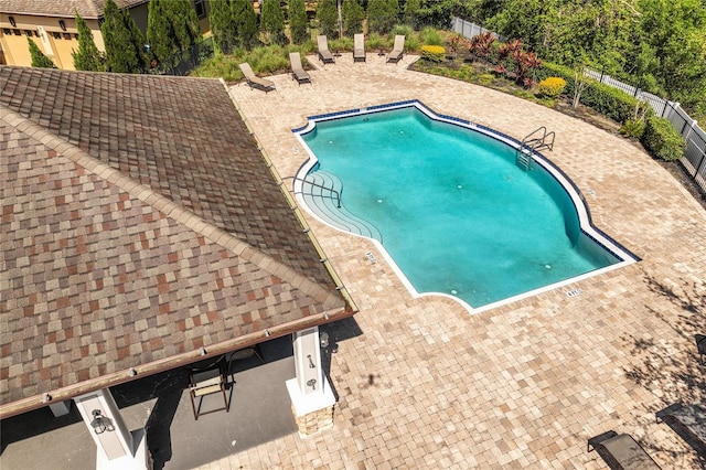 pool featuring fence and a patio