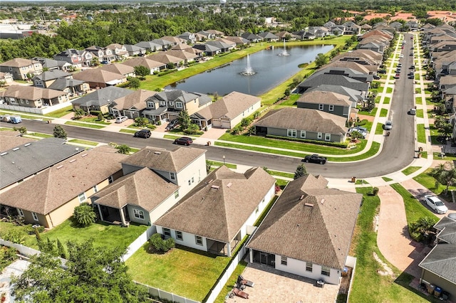 drone / aerial view with a water view and a residential view