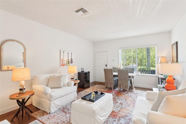 18187 Paradise Point Dr, Tampa, FL 33647 - living area featuring wood finished floors, baseboards, and a textured ceiling