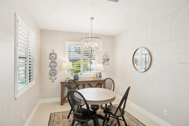 dining room featuring baseboards and a notable chandelier