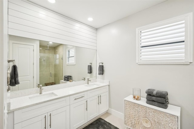 full bath featuring double vanity, a sink, recessed lighting, and a shower stall