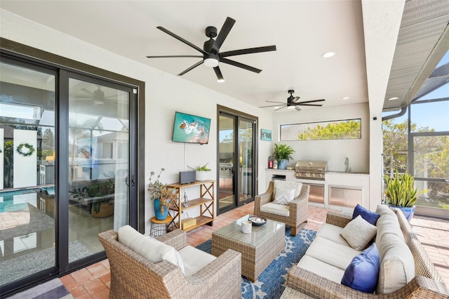 view of patio / terrace featuring a grill, exterior kitchen, an outdoor living space, a sink, and glass enclosure