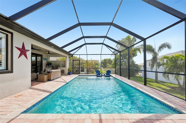 pool featuring a patio, ceiling fan, and glass enclosure