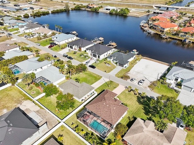 drone / aerial view with a residential view and a water view