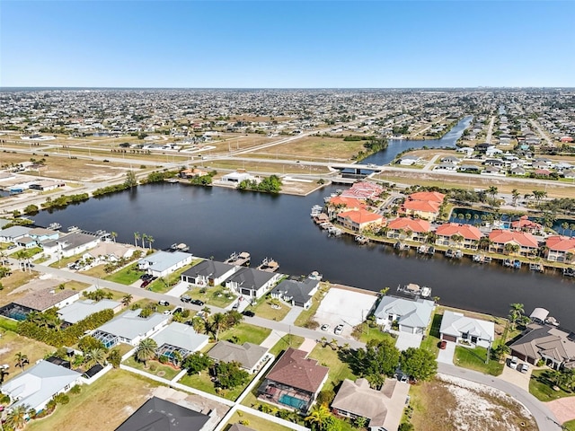 birds eye view of property with a residential view and a water view