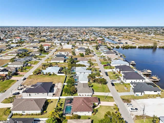 birds eye view of property with a residential view and a water view