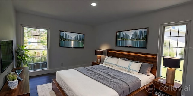 bedroom with baseboards, wood finished floors, and recessed lighting